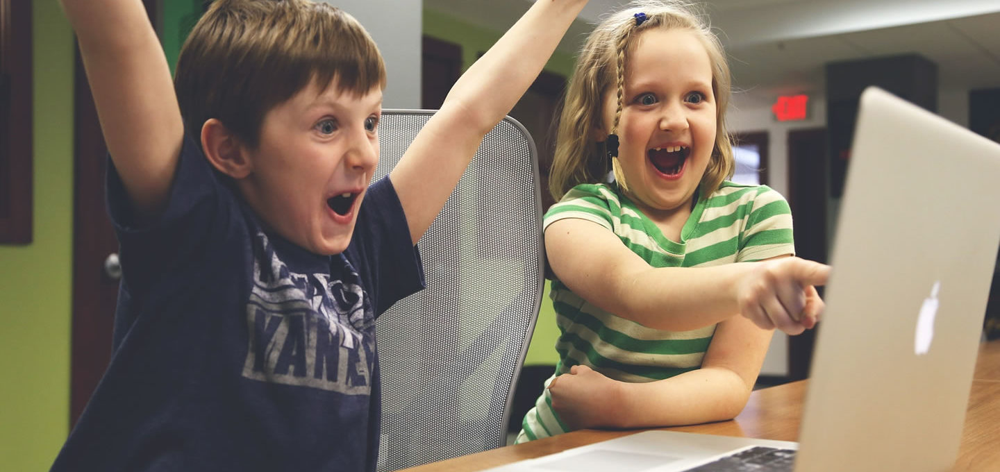 Children celebrate winning computer game