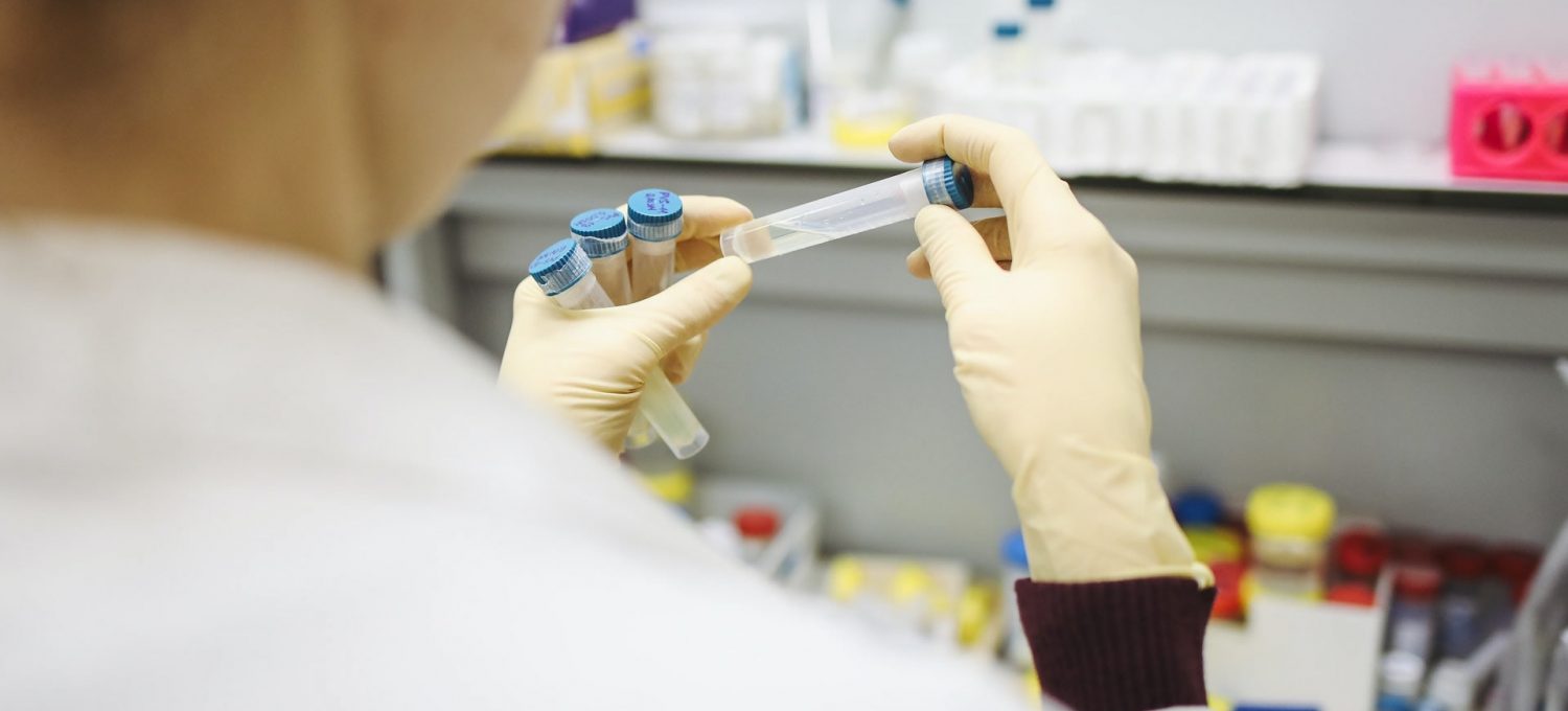 Science lab researcher with test tubes